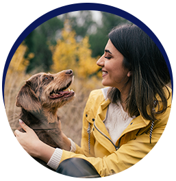 Woman and dog outdoors smiling