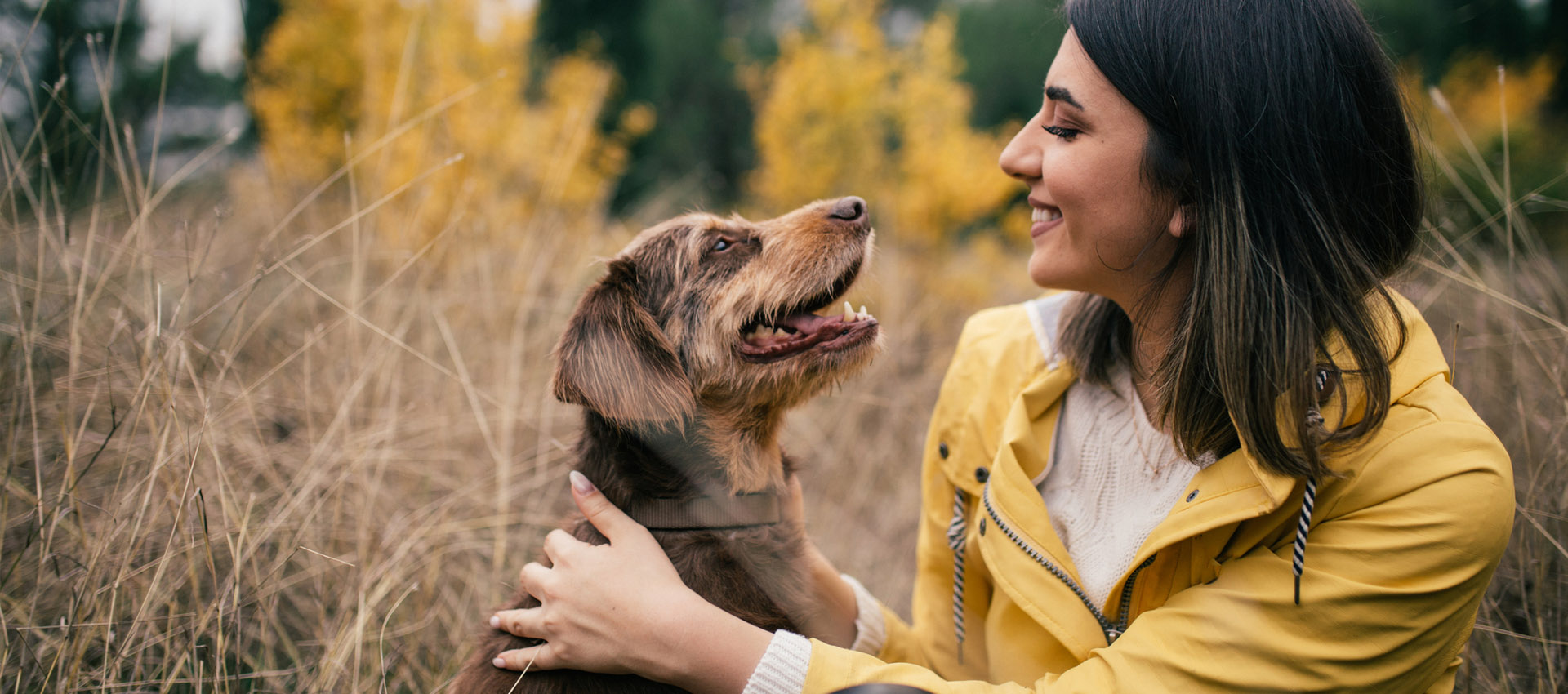 Smiling woman with happy dog